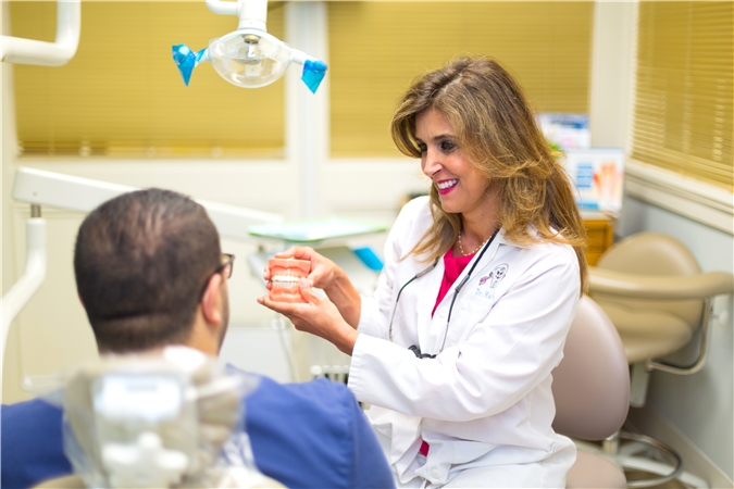 Dr. Firouzeh Manesh consulting with a patient at Encino Smile Care